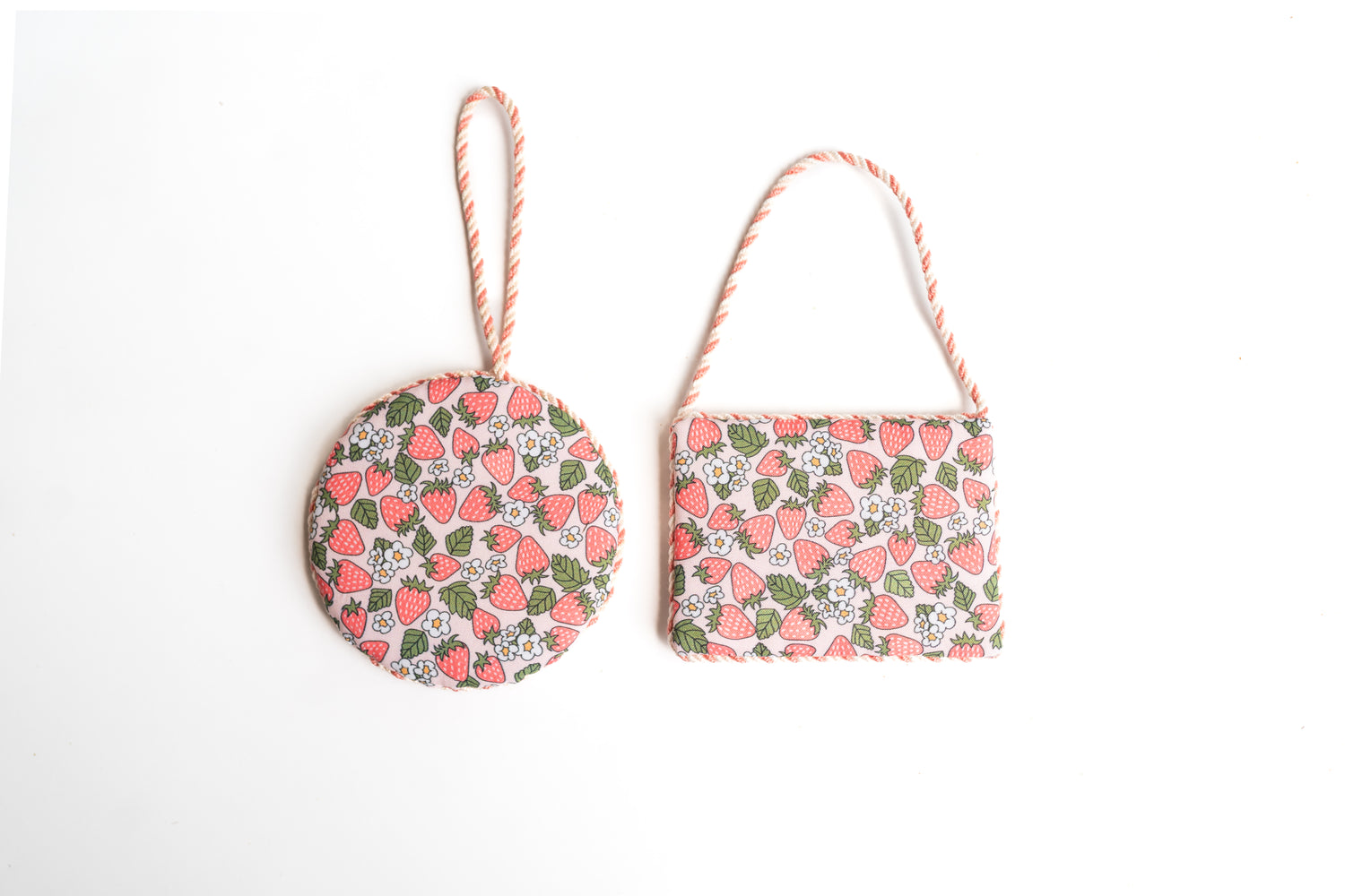 Needlepoint ornament finished with matching cording and square and round shape. Pink strawberry fabric. 