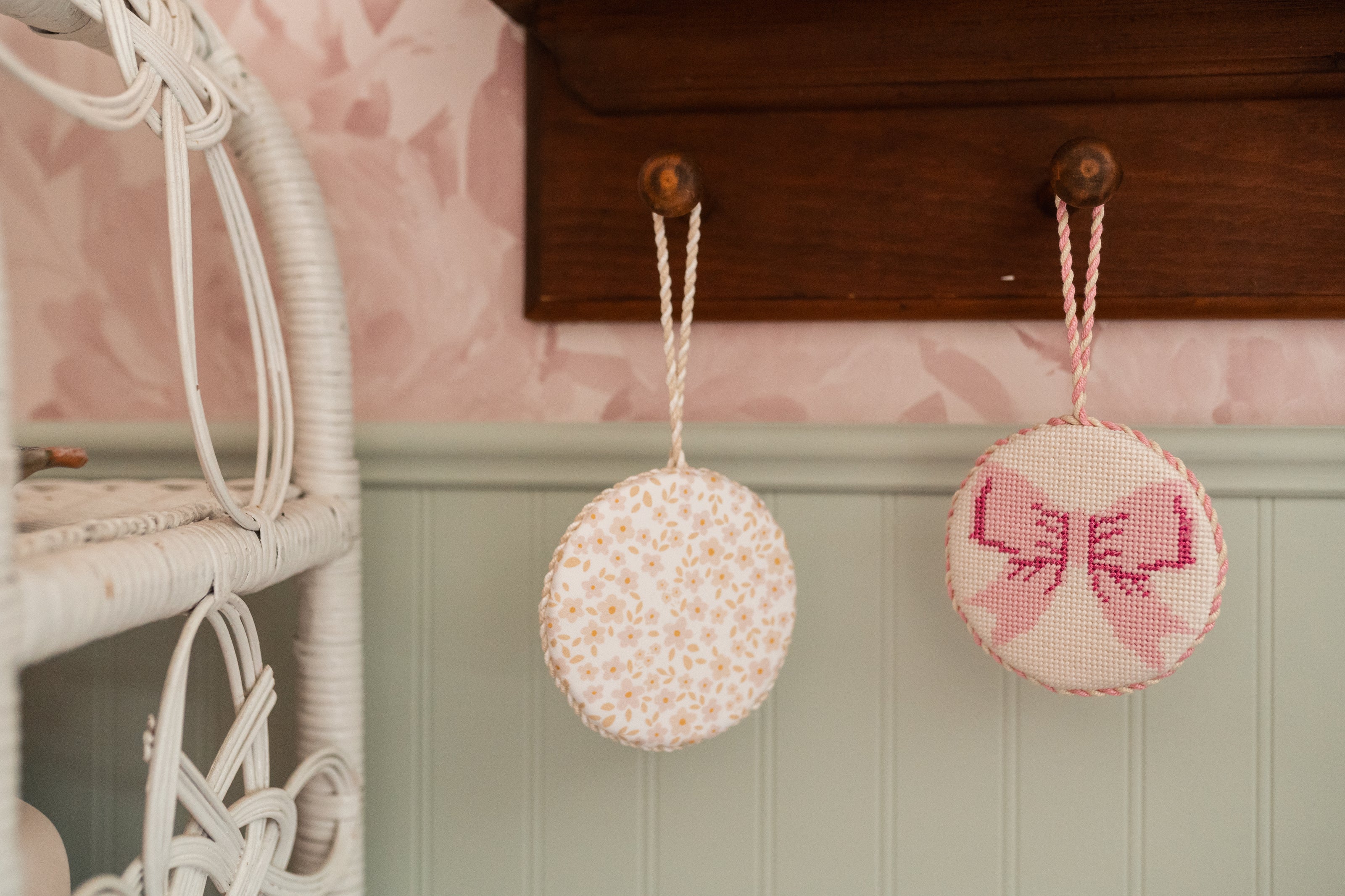 Collection of hand-finished needlepoint ornaments in curated fabrics and classic finishing styles.
